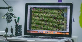 laptop with screen displaying dense data 