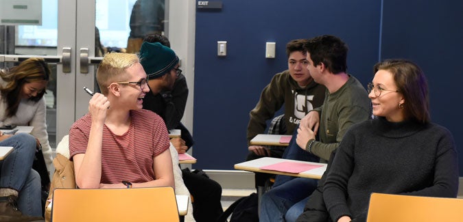 Students share a conversation in a political sciences classroom