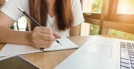 student doing homework at a desk