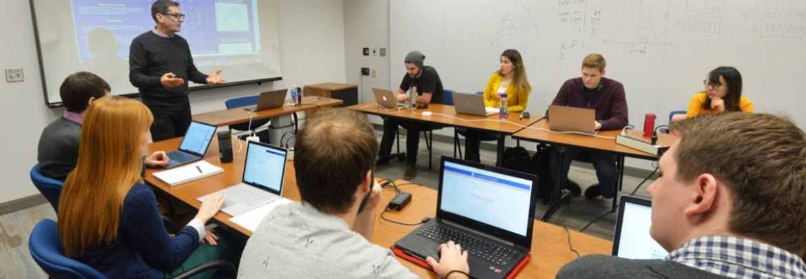 A professor leads his class in discussion.